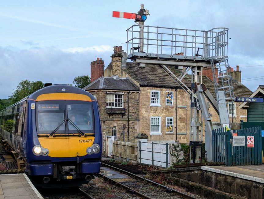 A vivid capture of a train arriving at Knaresborough station in England, showcasing historic charm.