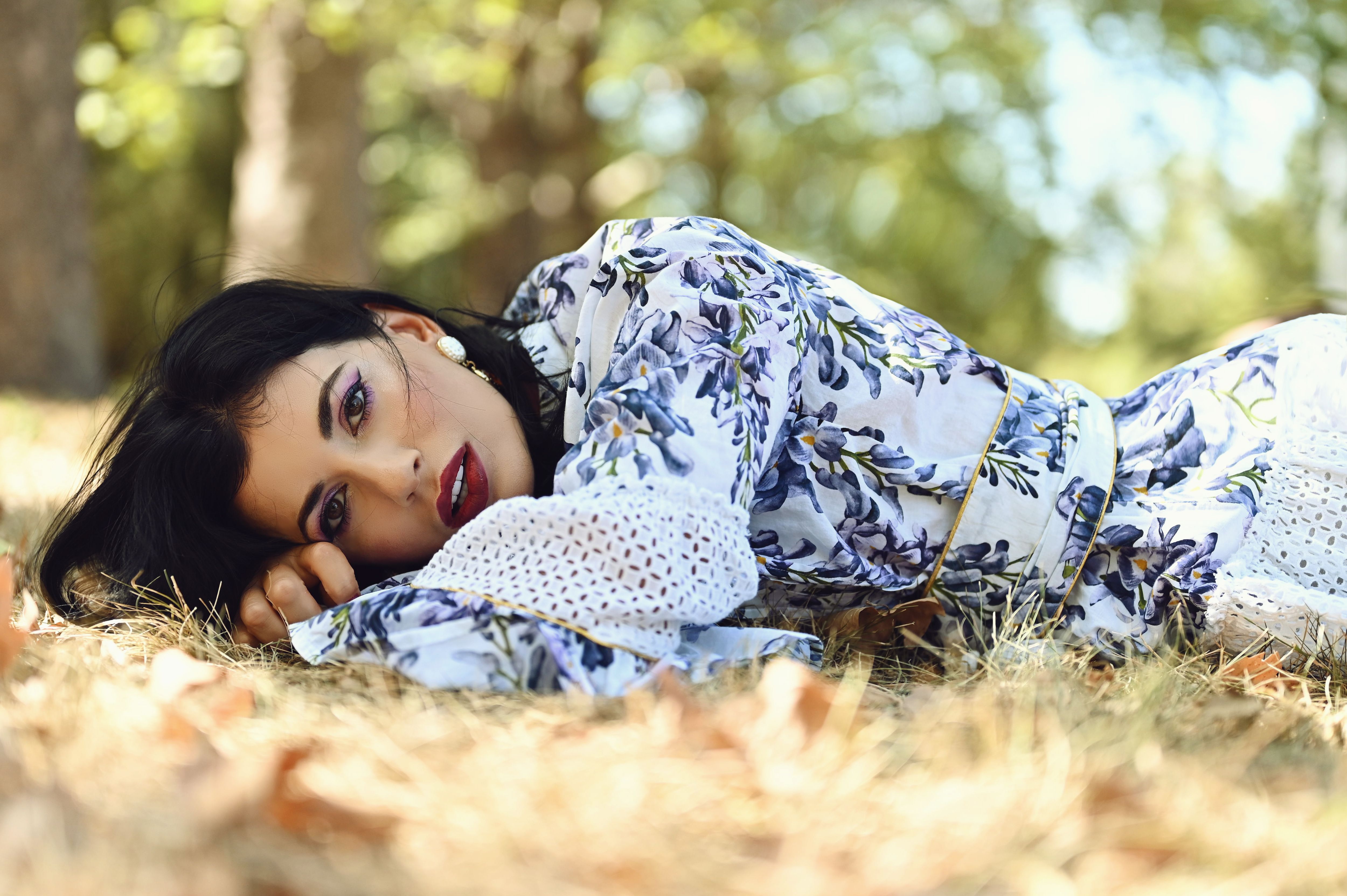 Elegant Woman in Floral Dress Relaxing Outdoors · Free Stock Photo