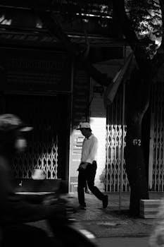 Captivating black and white shot of a city street, highlighting motion and light contrast.