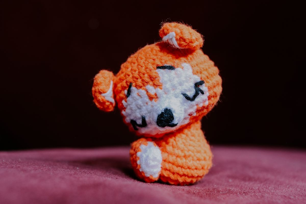 White crocheted lamb amigurumi toy with fluffy textured wool
