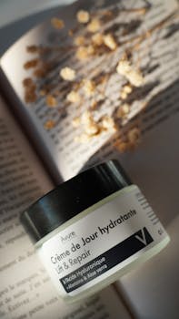 Perfectly lit day cream with dried flowers on a book.