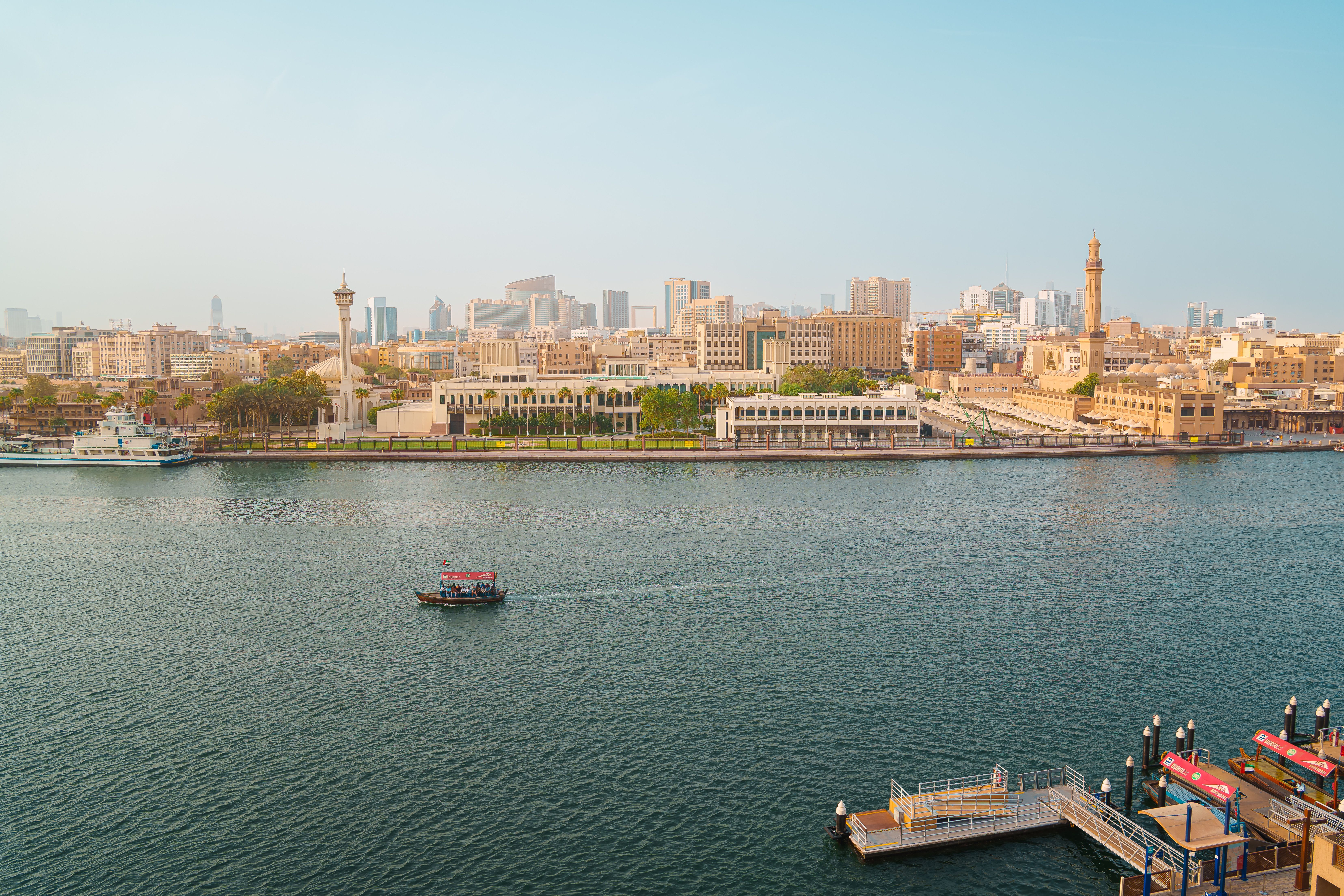 Scenic View of Dubai Creek Skyline with Abra Boats