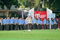 Indonesian event with participants in uniform during a flag ceremony outdoors.