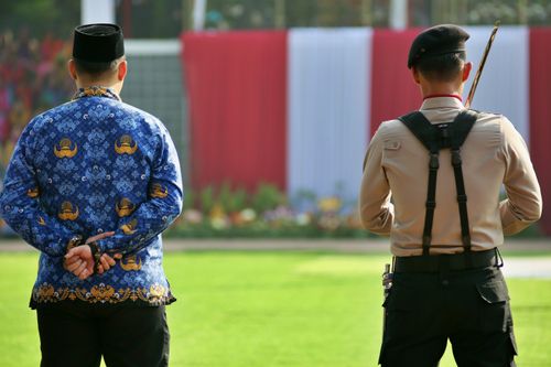 Free A formal outdoor ceremony featuring traditional and military dress uniforms. Stock Photo