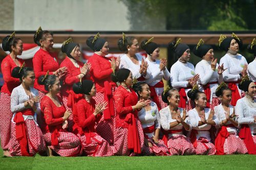 Free A group of women in traditional attire performing a cultural dance outdoors. Stock Photo
