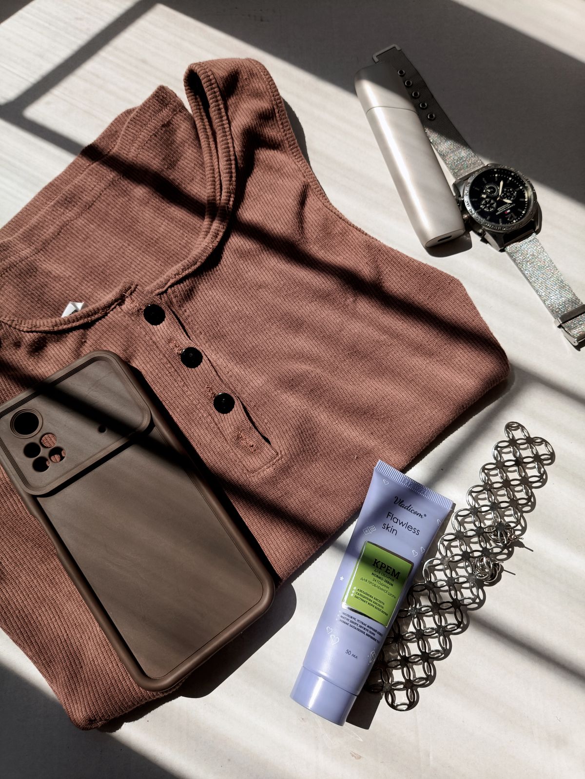 An elegant flat lay of a structured garment and scarf
