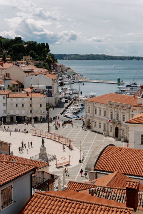 Free Aerial view of the picturesque coastal town of Piran, Slovenia, showcasing its charming harbor and historic architecture. Stock Photo