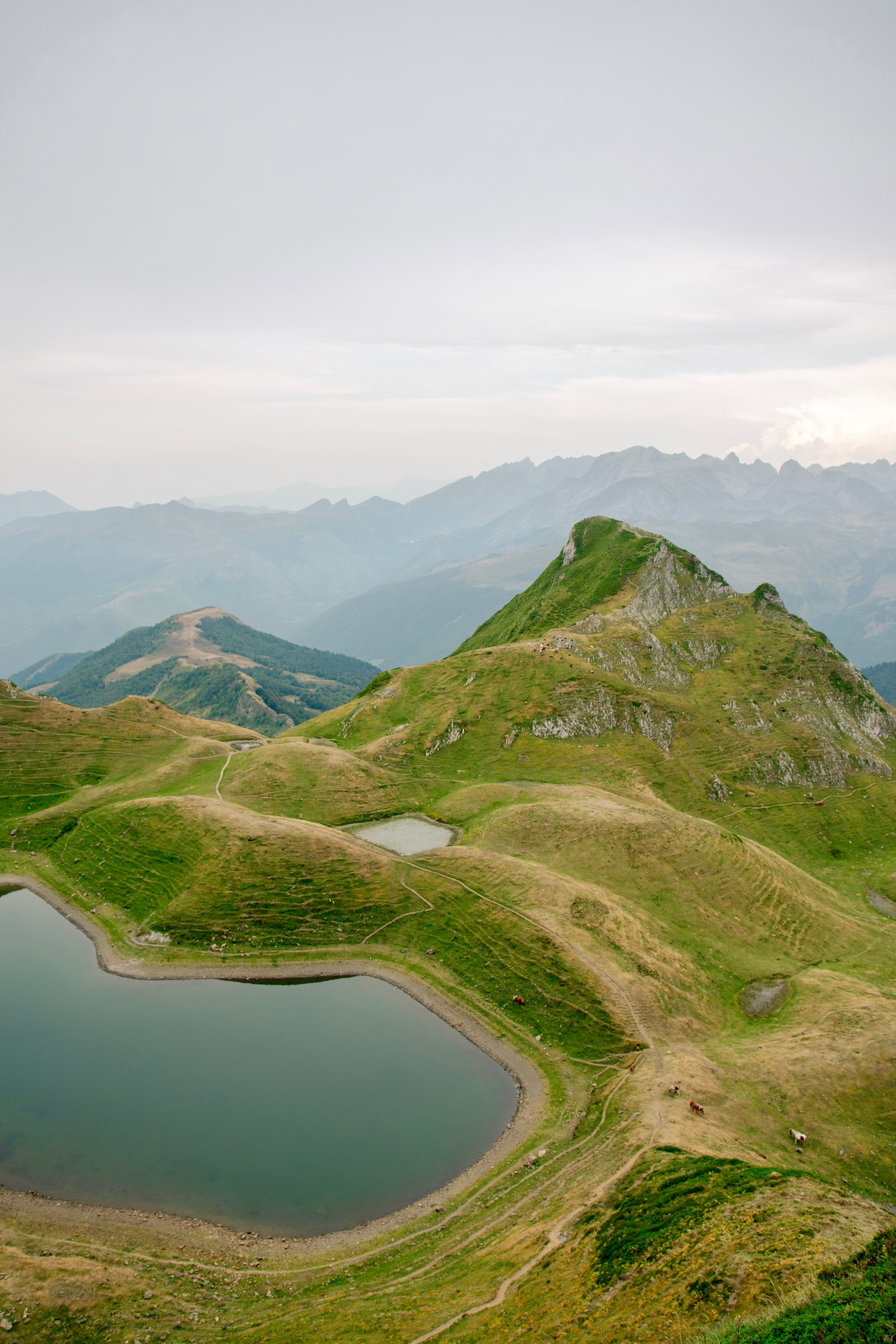 A tranquil mountain scene with a serene lake amid rolling hills, perfect for nature lovers.