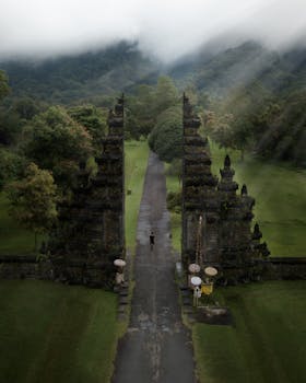 A stunning aerial view of the iconic Handara Gate amidst lush greenery in Bali, Indonesia.