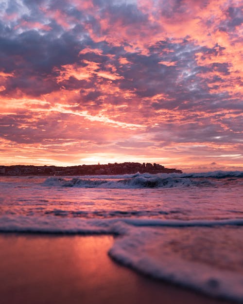 Waves Crashing on the Shore during Sunset