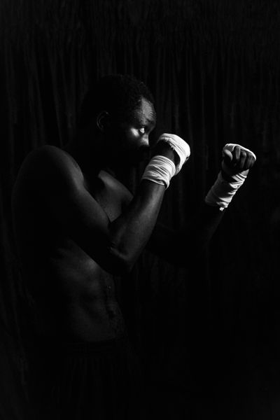 Black and white portrait of a boxer with wrapped hands — Blessing Niniola on Pexels