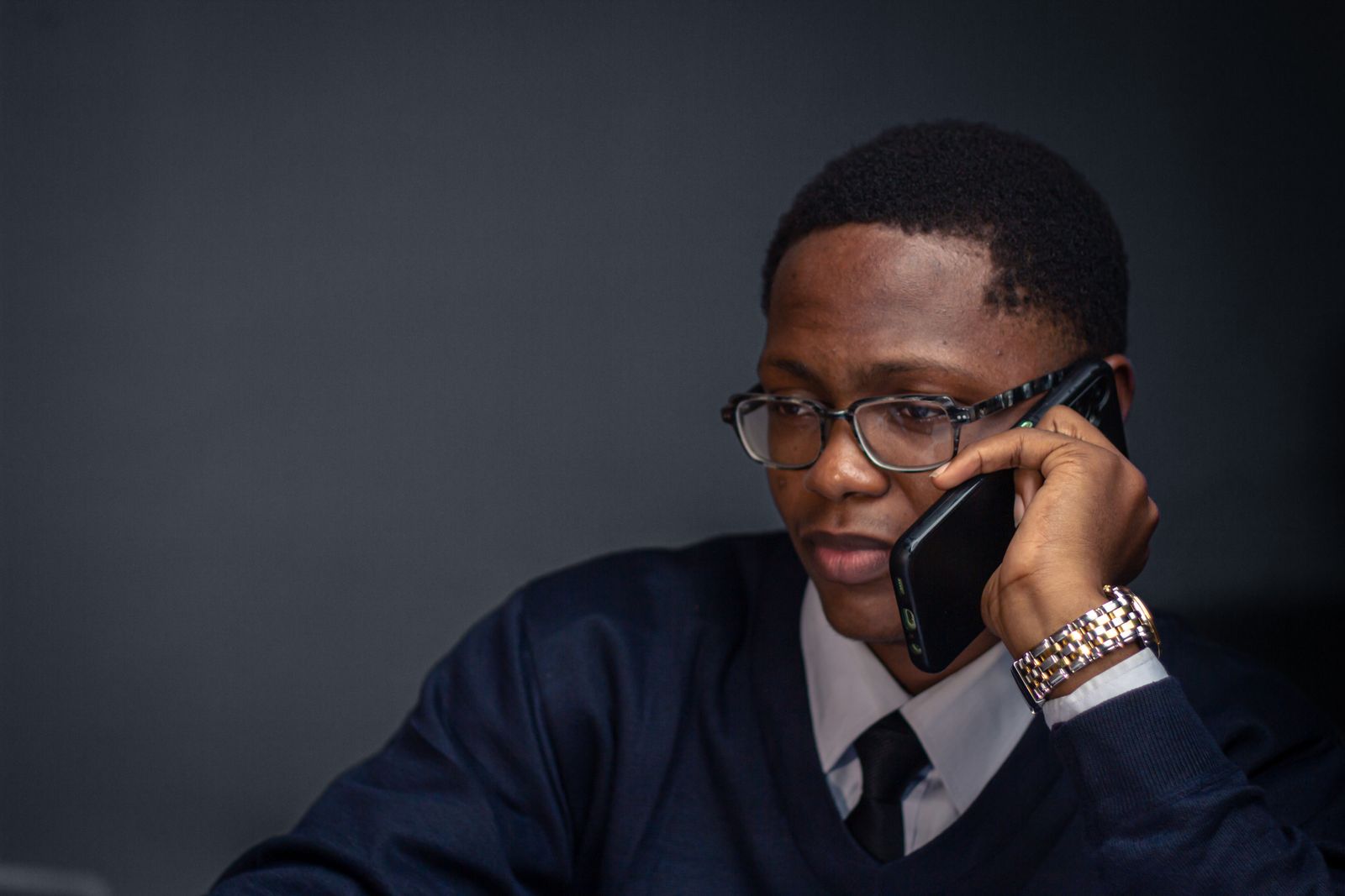 Calm professional using a phone in a workplace setting