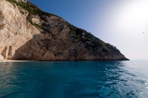 Free Beautiful coastal cliffs meeting turquoise waters under a clear sky, showcasing natural beauty. Stock Photo