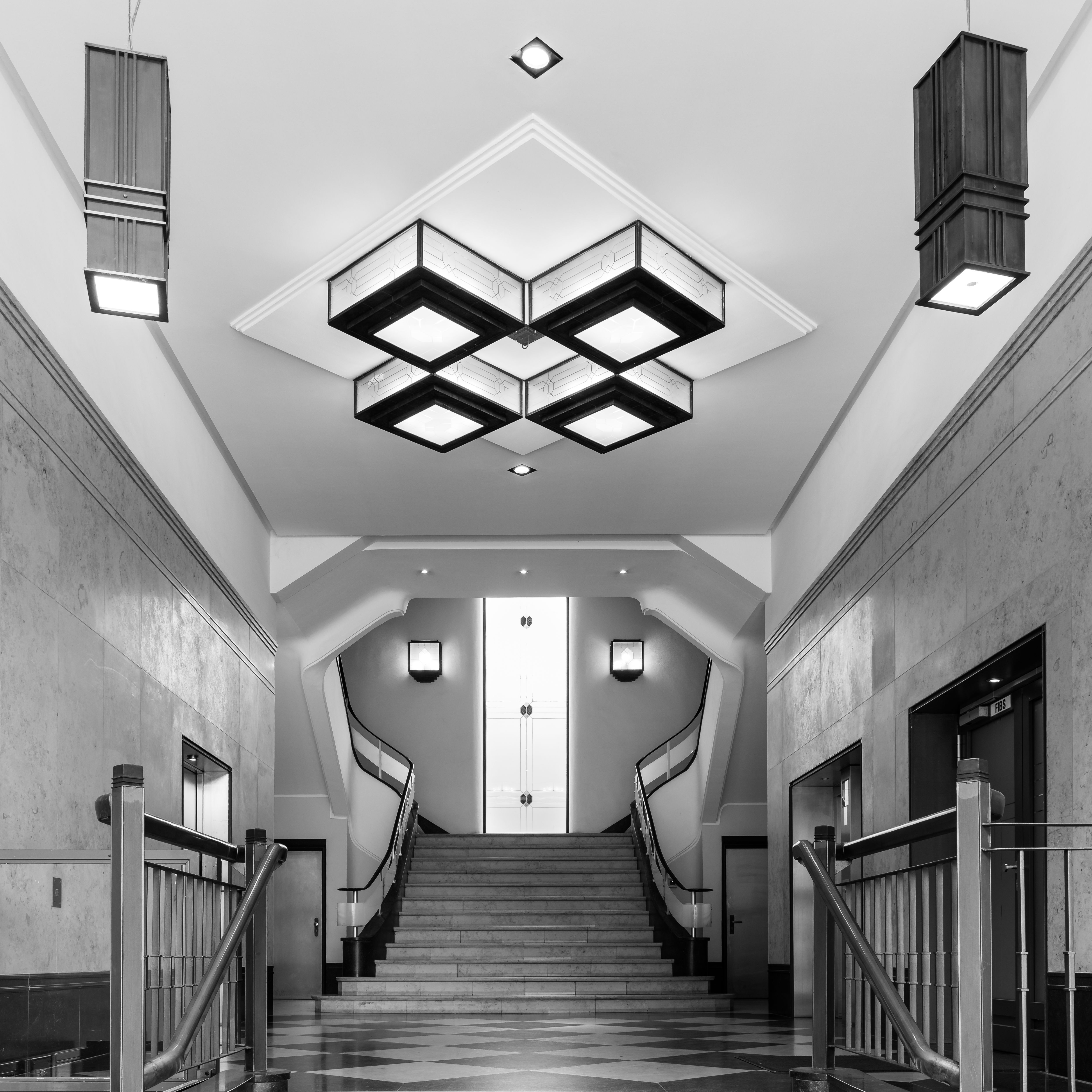 Black and white photo of a stylish spiral staircase in a historic Hamburg building.