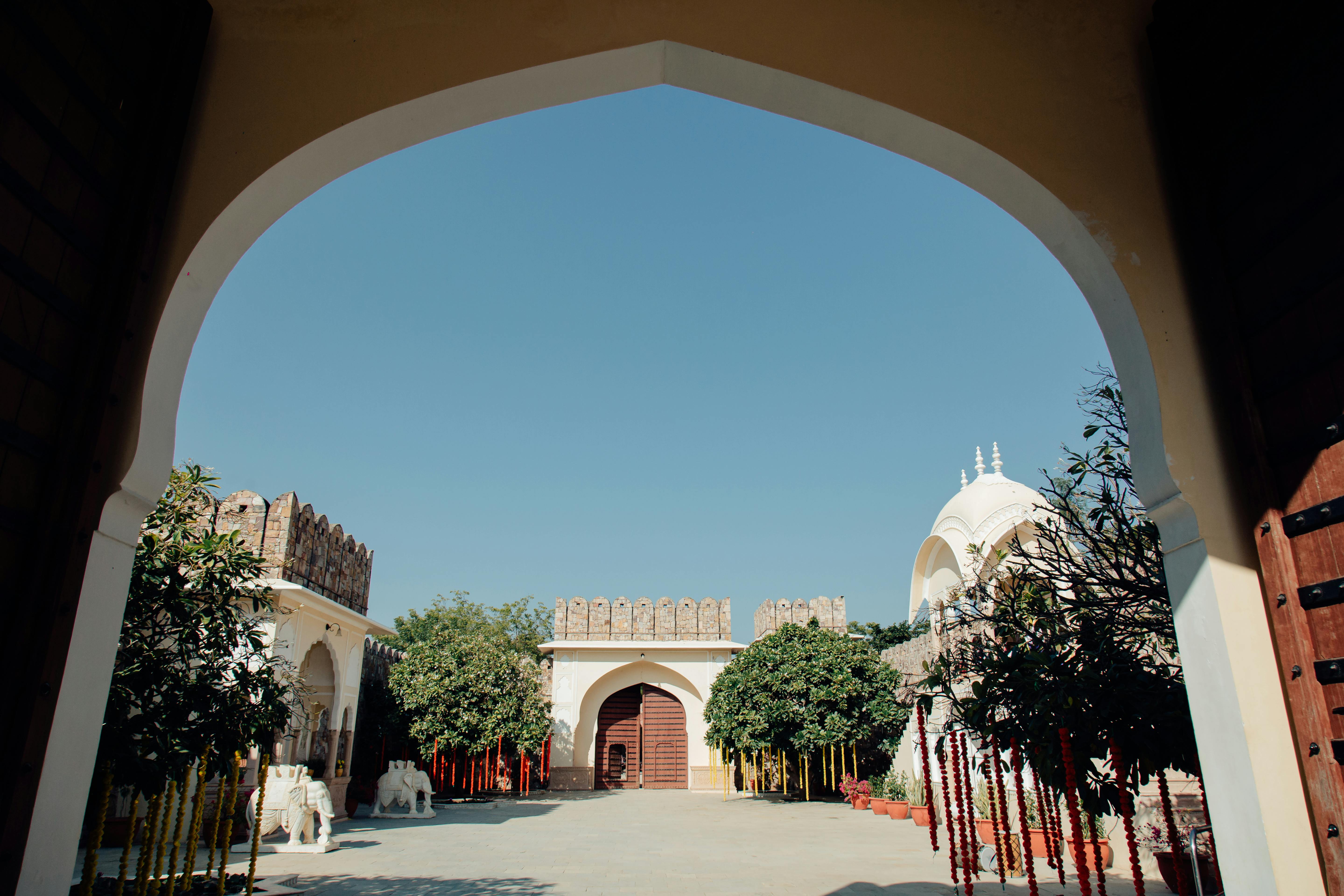Traditional Indian courtyard with arches and lush garden