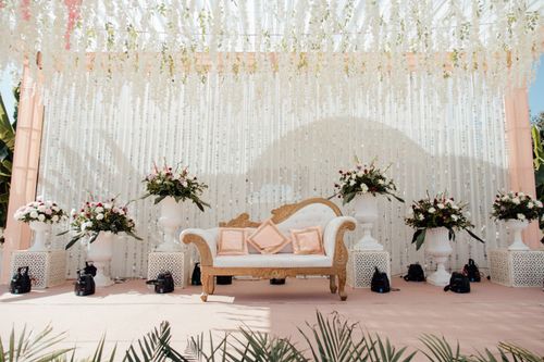 Free Luxurious outdoor wedding stage adorned with floral arrangements and elegant seating. Stock Photo