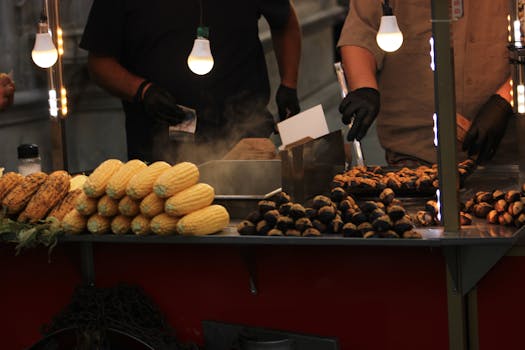 Street market scene in Istanbul with roasted corn and chestnuts for sale under warm lights.