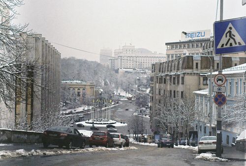 Free Capture of a snowy street in Kyiv, Ukraine, showcasing winter cityscape and architecture. Stock Photo