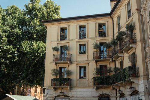Free A beautiful classic building in Verona, Italy with lush balconies. Stock Photo