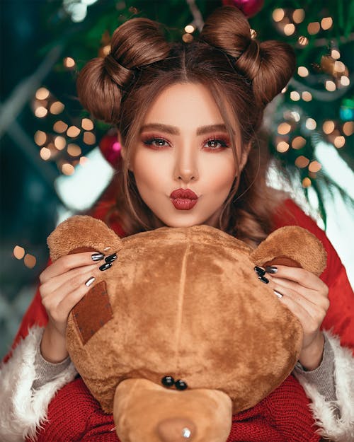 Shallow Focus Photo of Woman Holding Brown Bear Plush Toy