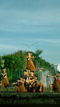 Colorful traditional Indonesian dance captured in a vibrant outdoor setting.