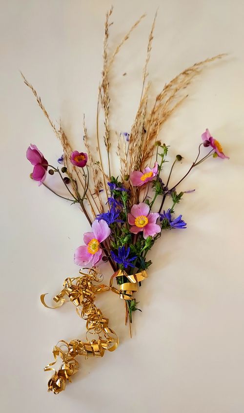 Free A beautiful floral arrangement with pink and blue flowers accented by golden ribbons. Stock Photo