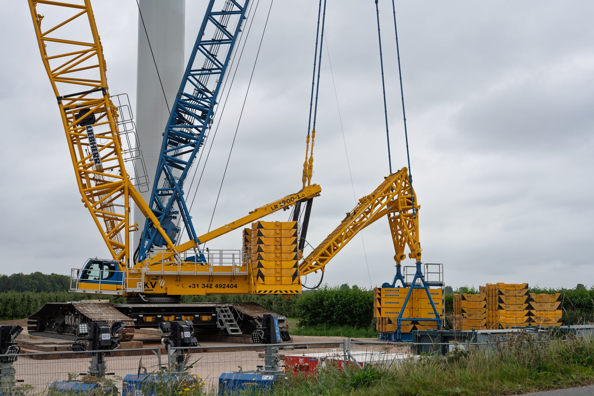 Crane lifting heavy project cargo at a construction site