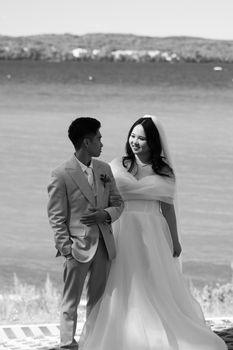 Stunning black and white wedding portrait of a couple by a scenic beach in Jönköping, Sweden.