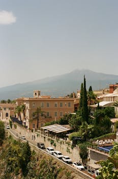 Beautiful panoramic view of Taormina, Sicily with Mount Etna in the background, captured on film.