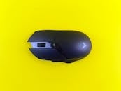 Black Gaming Mouse on Vibrant Yellow Background