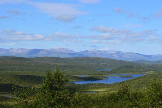 Majestic view of lakes and mountains in Porsangmoen, Finnmark, Norway on a sunny day.