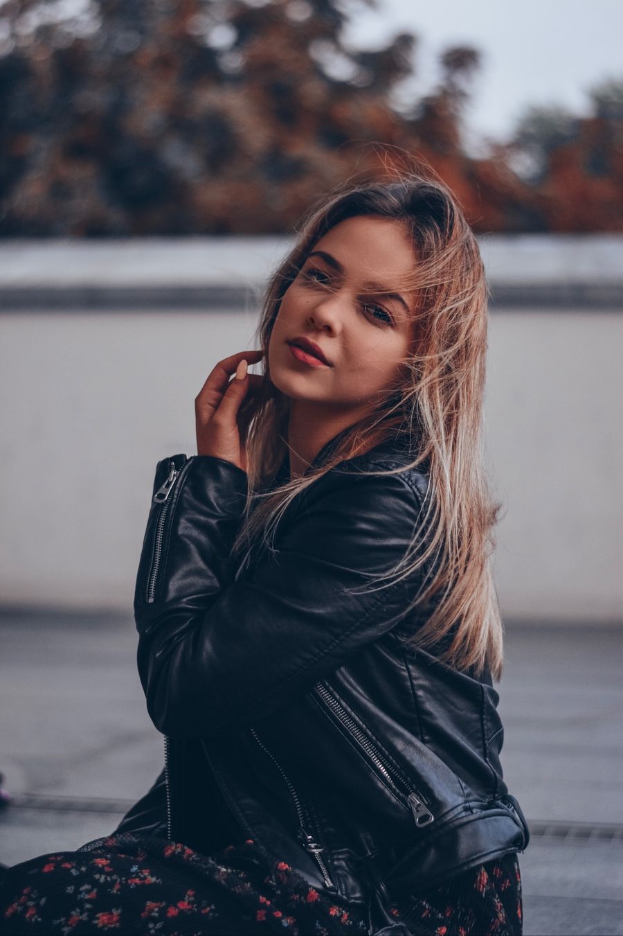 Woman in a black leather biker jacket outdoors