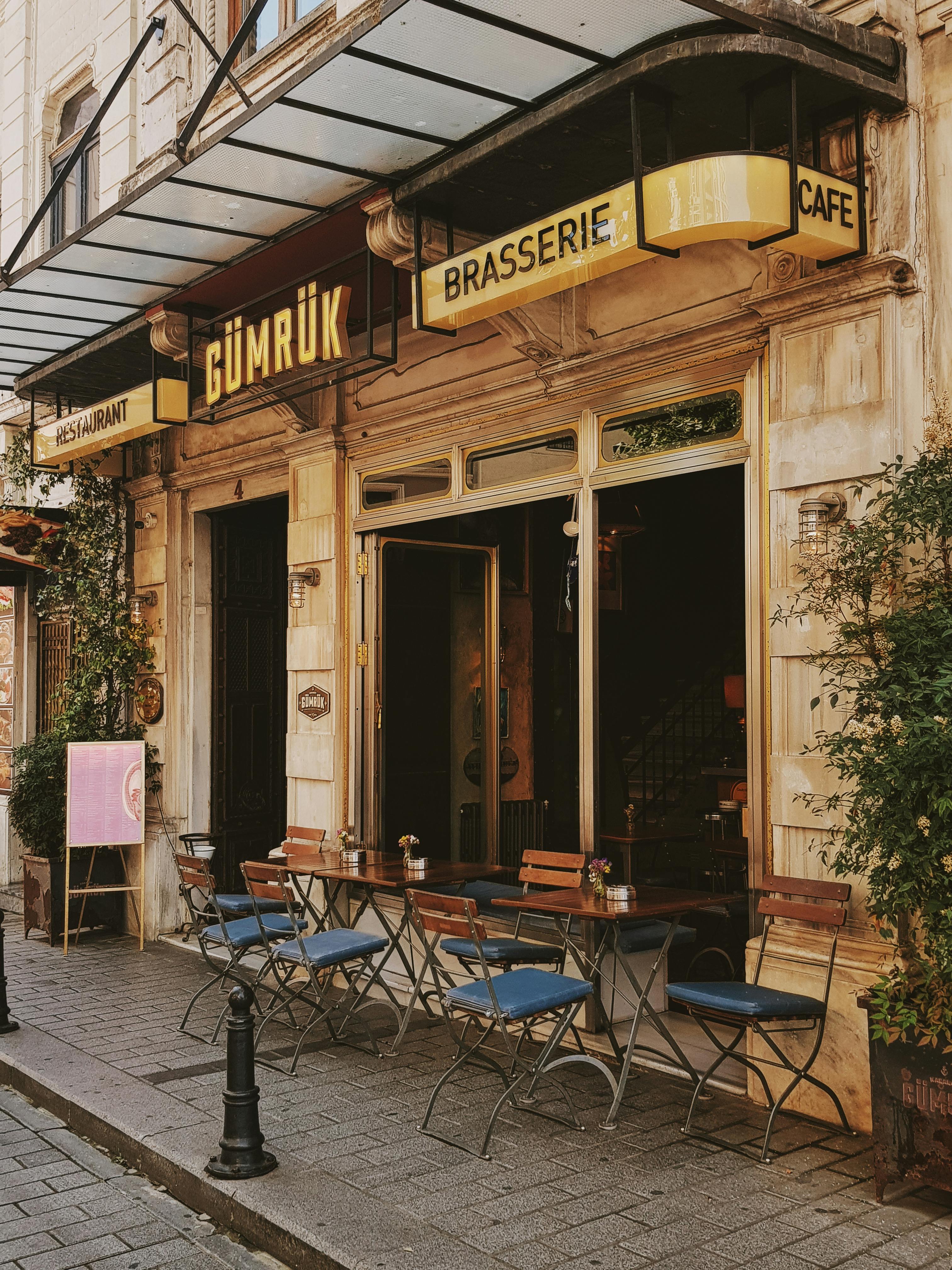 Charming street cafe in Istanbul, showcasing vintage architecture and inviting outdoor seating.