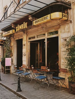 Charming street cafe in Istanbul, showcasing vintage architecture and inviting outdoor seating.