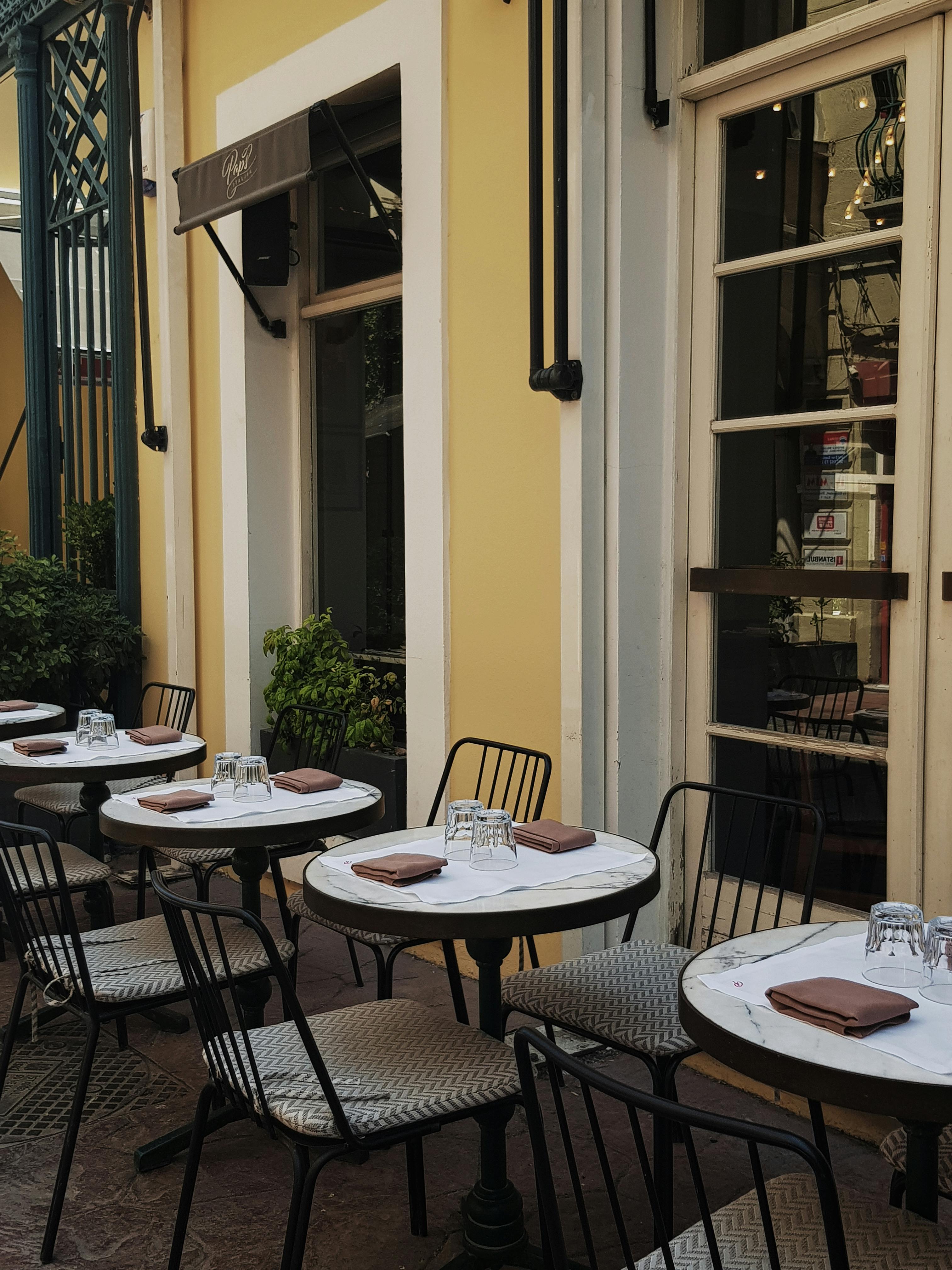 A quaint outdoor café with neatly set tables, perfect for a sunny day in Istanbul.