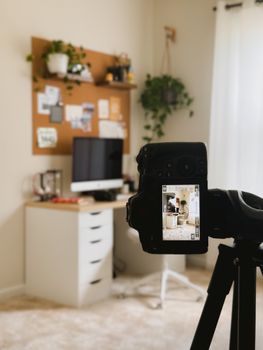 Modern home office with camera setup capturing a workspace with desk and computer.
