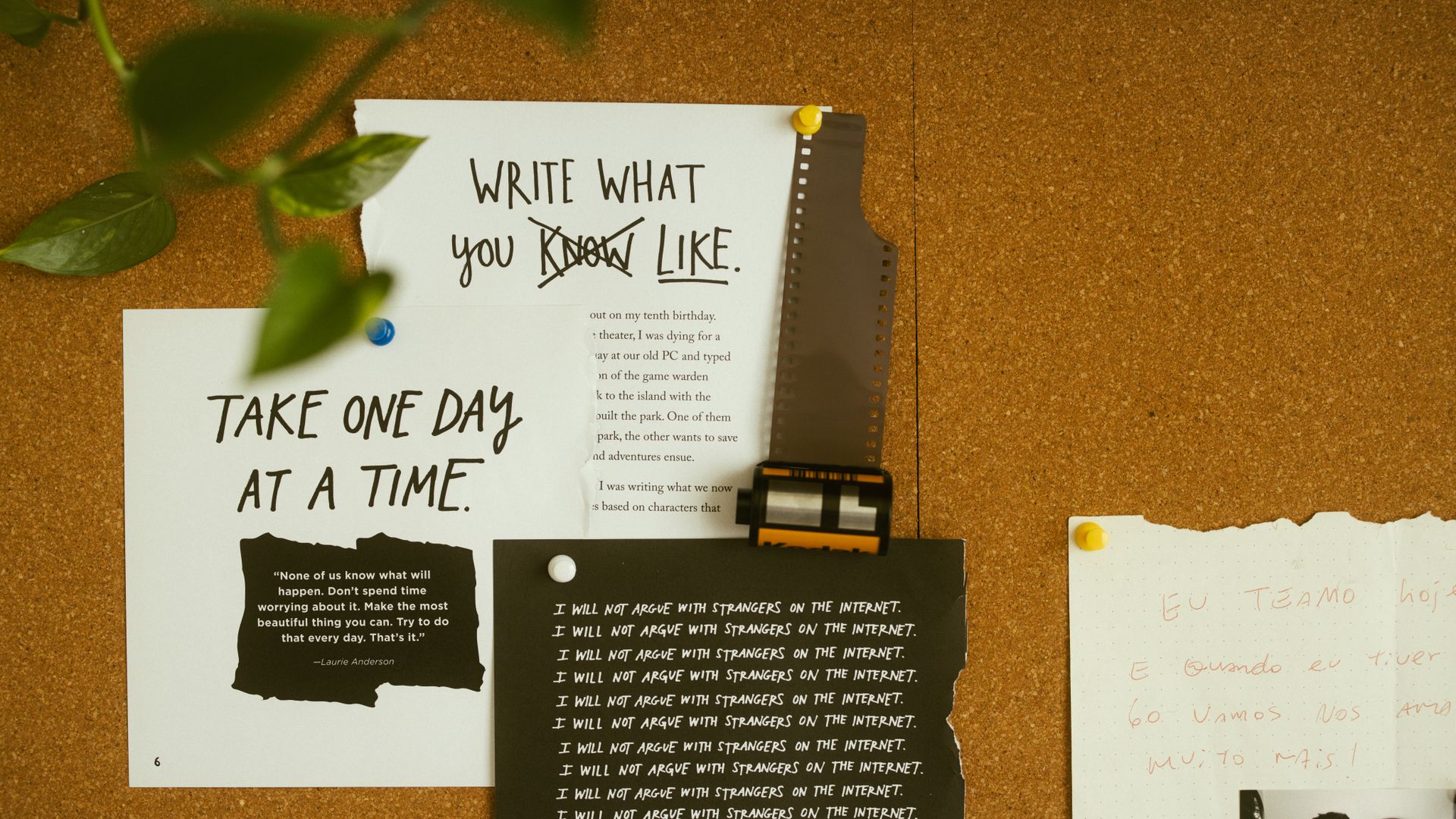 A corkboard with motivational quotes, notes, and film negatives, fostering creativity and reflection — what is ars