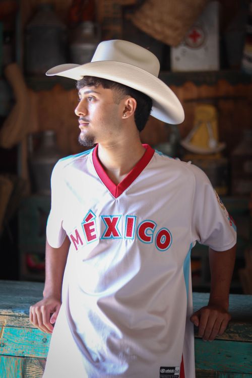Free Portrait of a young man in a Mexican jersey and cowboy hat in León de los Aldama, Mexico. Stock Photo