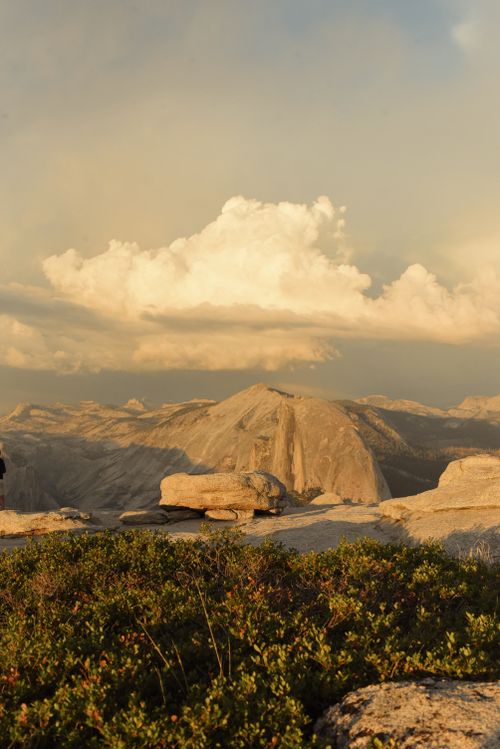 Free Golden hour over Half Dome in Yosemite, California with dramatic clouds and lush foreground. Stock Photo