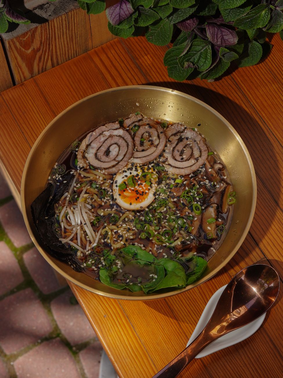 Bowl of tantanmen ramen with creamy sesame broth, ground pork, and scallions