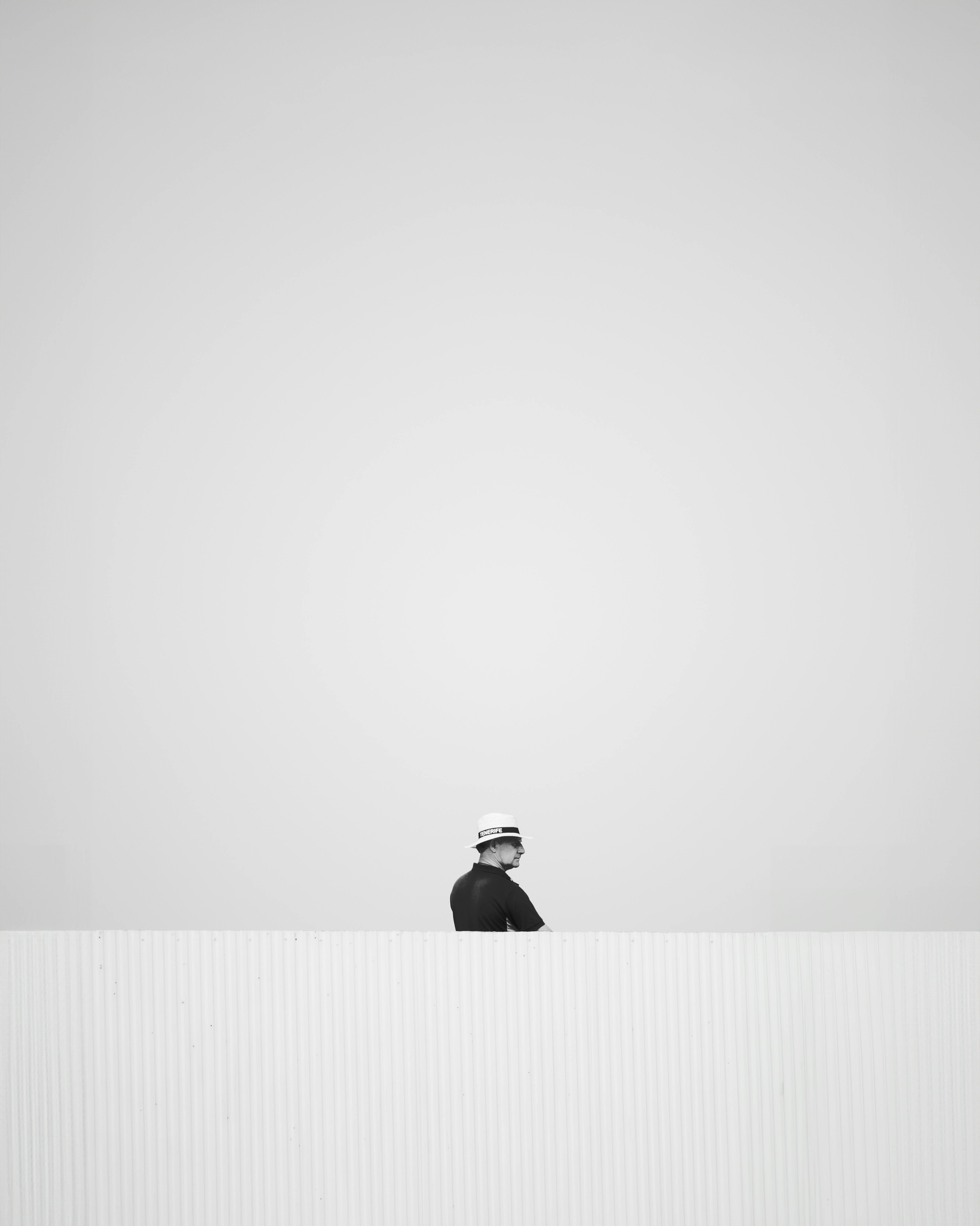 Free A minimalist black and white photo of a worker outdoors in Spain. Stock Photo