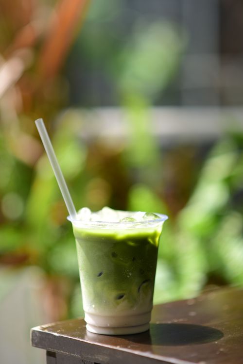 Free Chilled iced matcha latte in sunlight, perfect for summer days. Stock Photo
