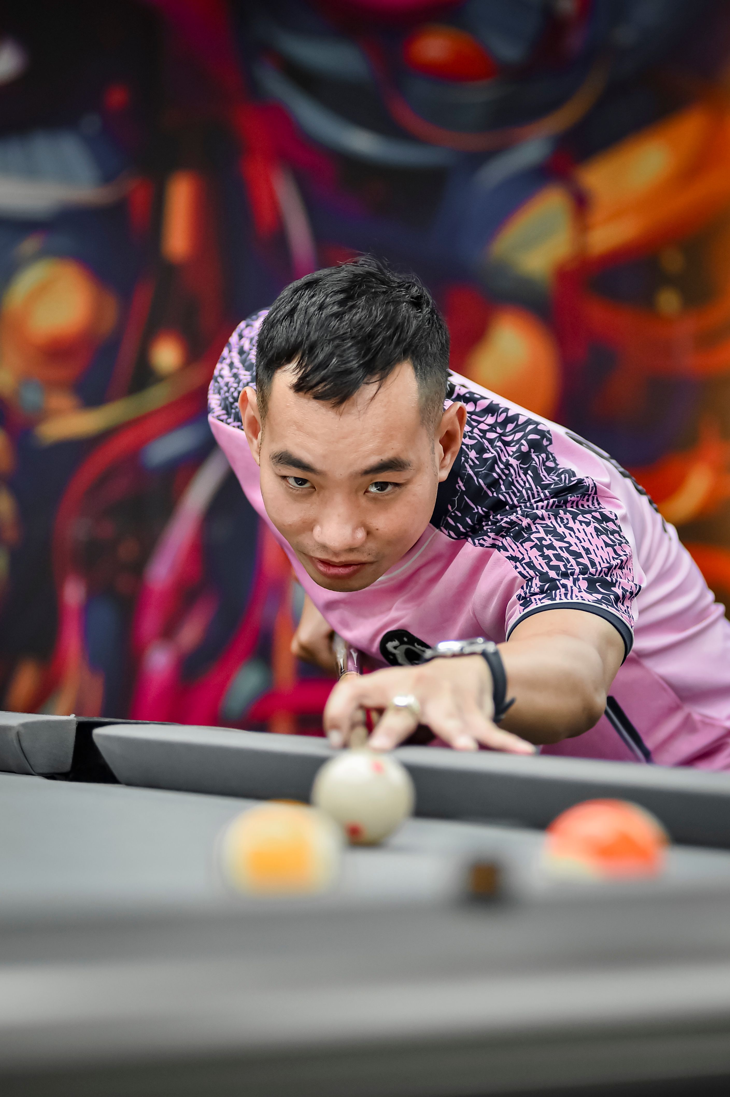 Focused Pool Player Aiming for a Shot Indoors