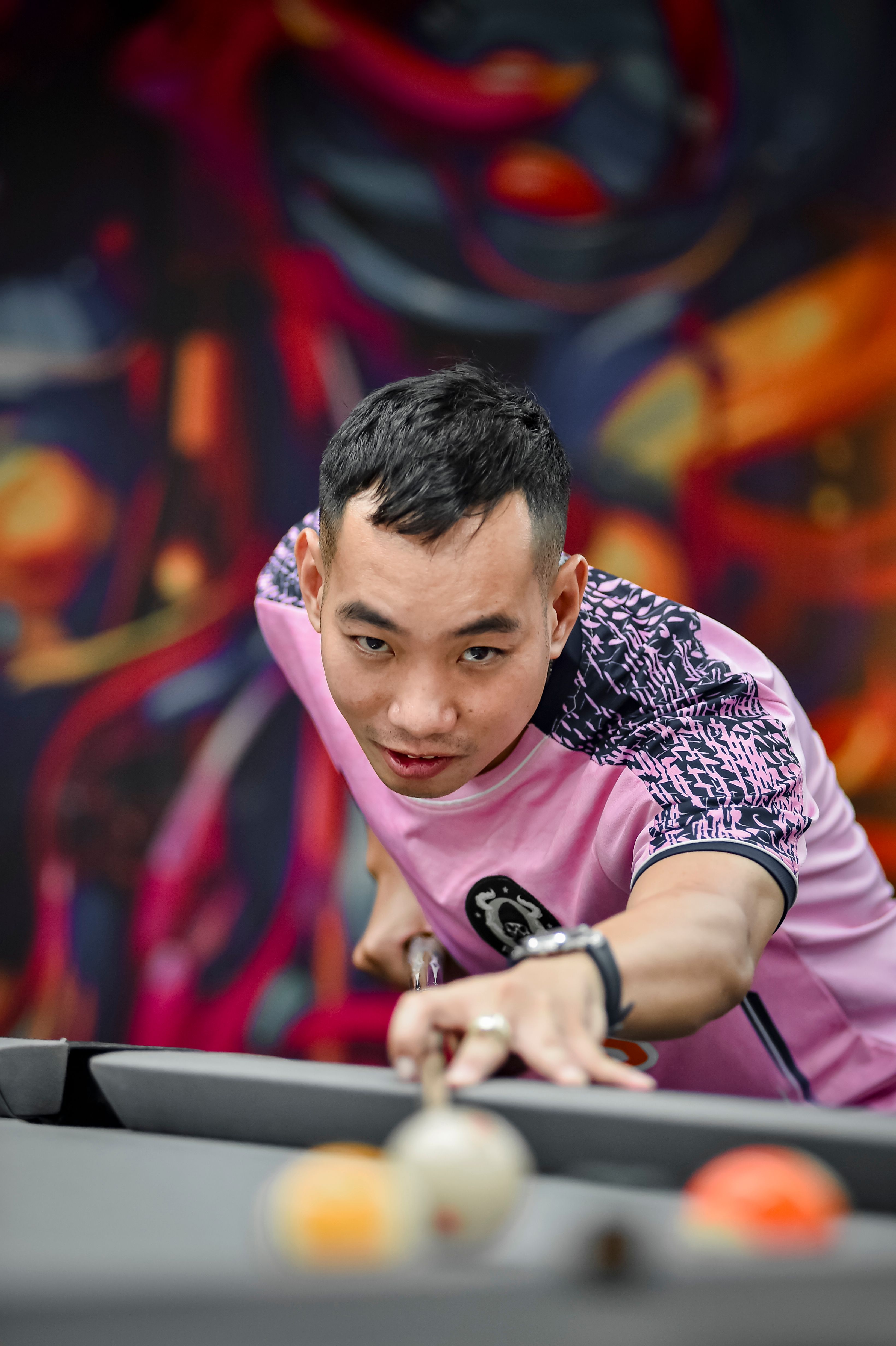 Focused Billiards Player in Vibrant Hanoi Setting