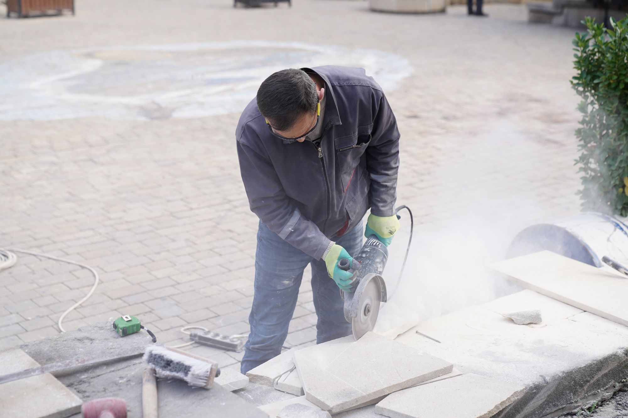 Tile setter cutting stone tile