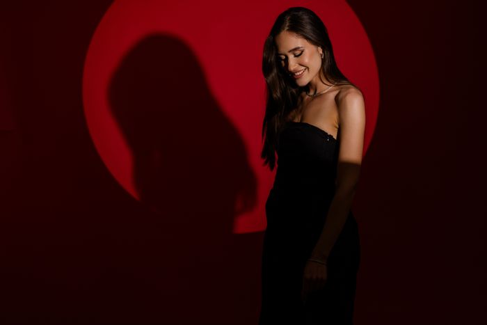 Studio portrait on a deep red backdrop — Lazarus Ziridis on Pexels