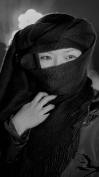 A captivating portrait of a woman in a black scarf, conveying mystery and elegance.