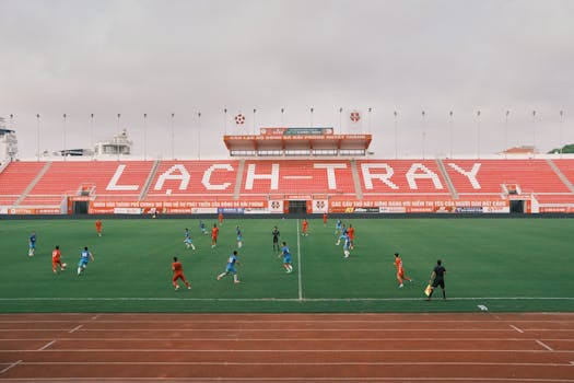 A soccer match underway at Lạch Tray Stadium in Hải Phòng, Vietnam, showcasing vibrant sports action.
