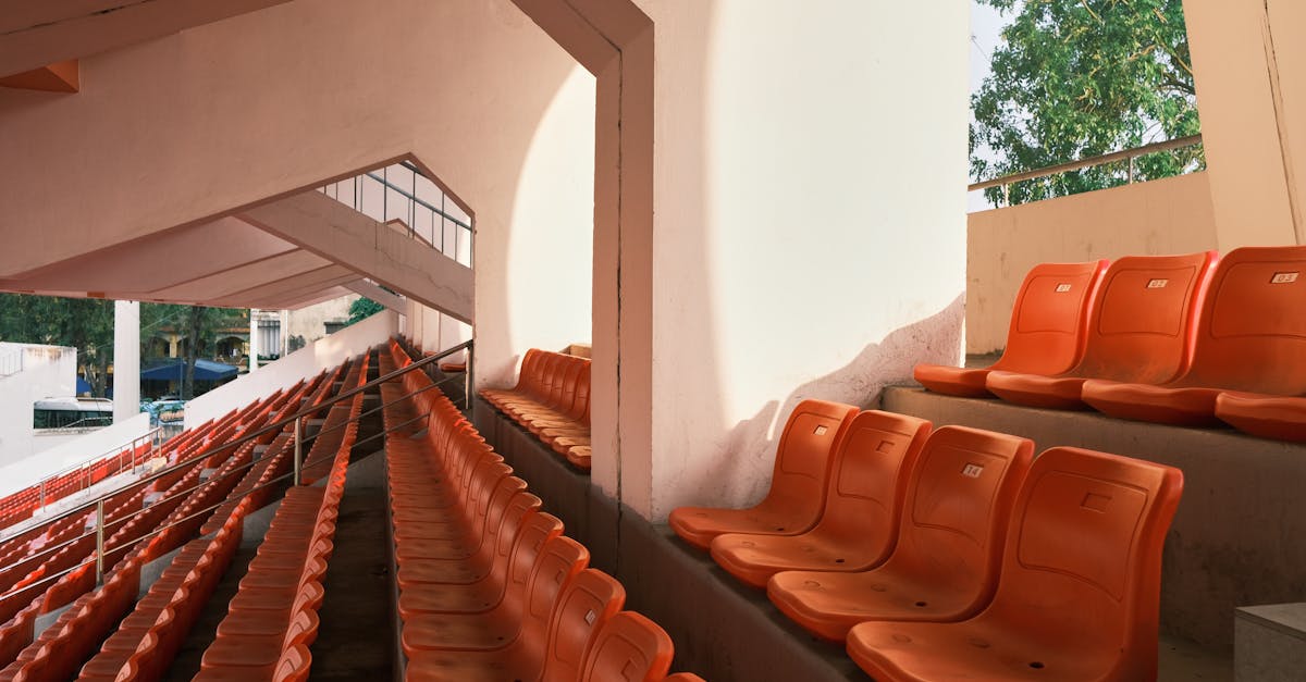 Empty orange stadium seats in Hải Phòng, Vietnam, during the day.