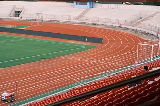 Spacious empty sports stadium with running track and seating in Hải Phòng, Vietnam.